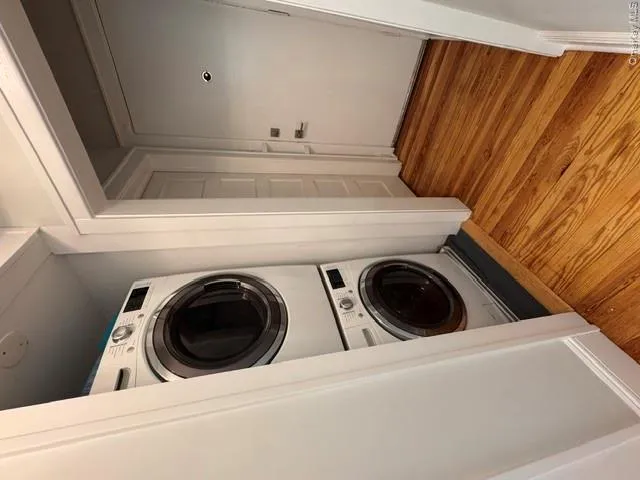 Integrated laundry closet featuring a stacked washer and dryer Integrated laundry closet featuring a stacked washer and dryer