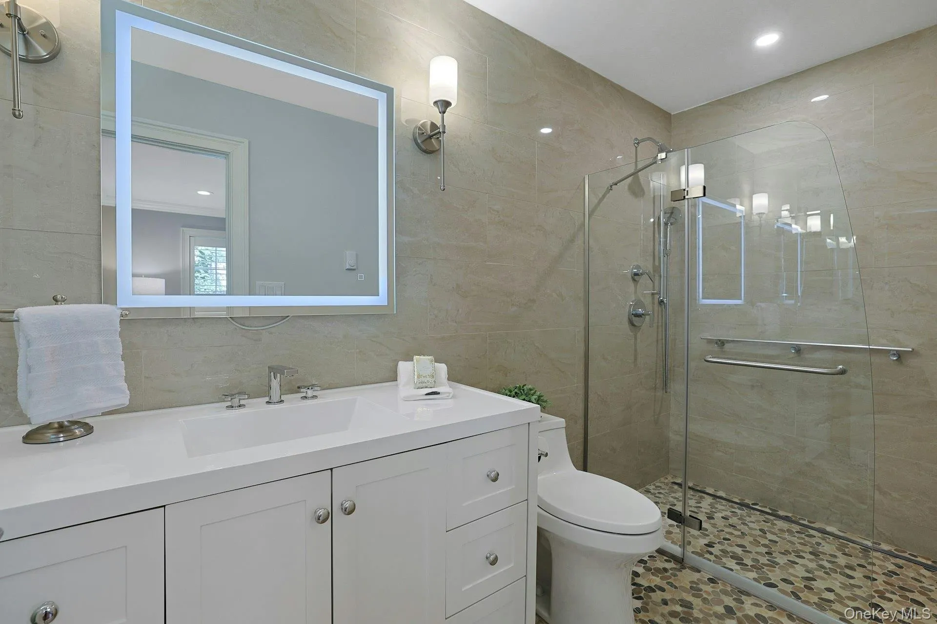 Spacious renovated ensuite bath with a large vanity and glass-enclosed shower just steps from the bedroom. Spacious renovated ensuite bath with a large vanity and glass-enclosed shower just steps from the bedroom.