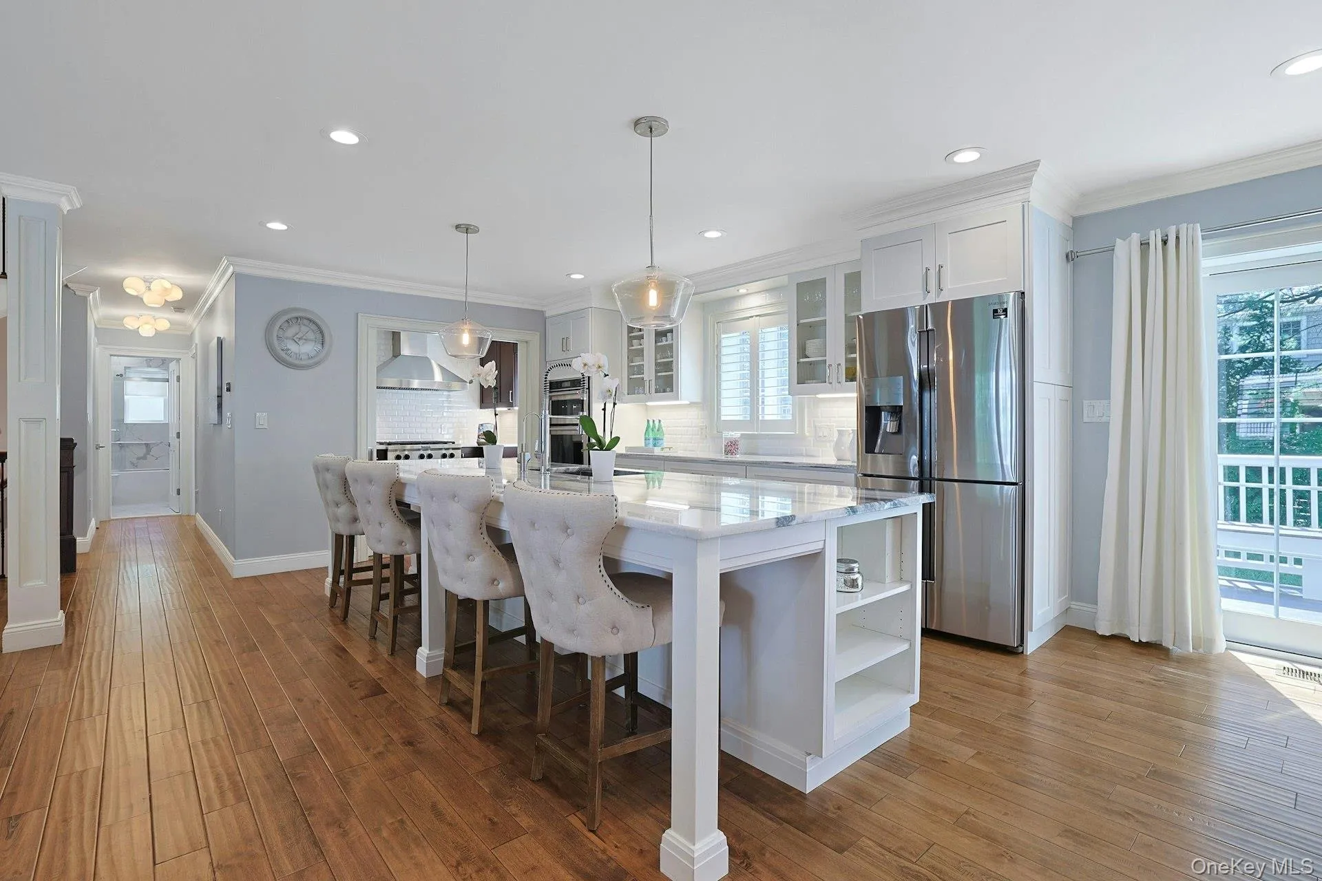Spectacular chef's kitchen with oversized stone island and abundant seating. Spectacular chef's kitchen with oversized stone island and abundant seating.