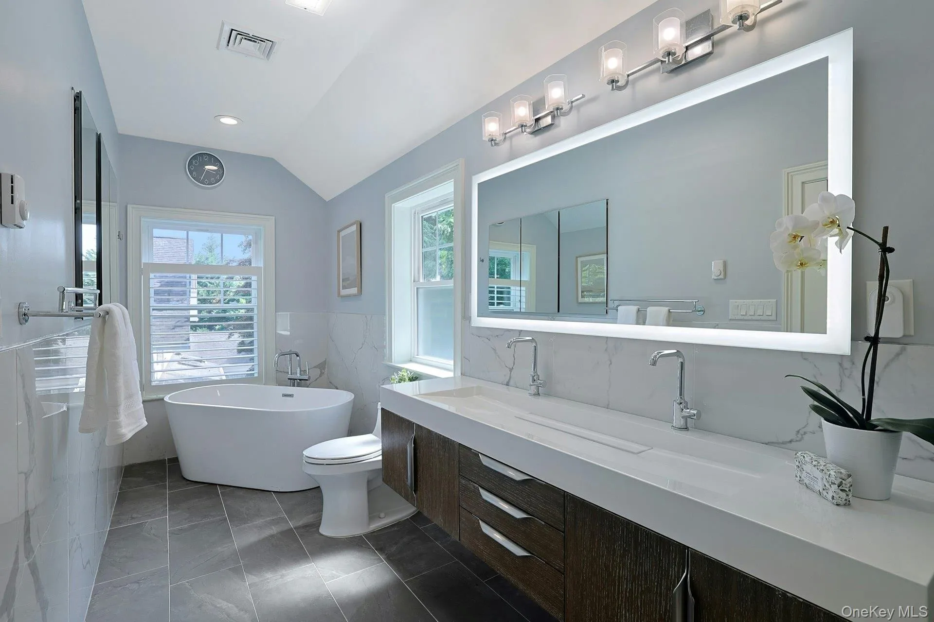 Spa-inspired primary bath with trough-style vanity, soaking tub, and oversized shower. Spa-inspired primary bath with trough-style vanity, soaking tub, and oversized shower.