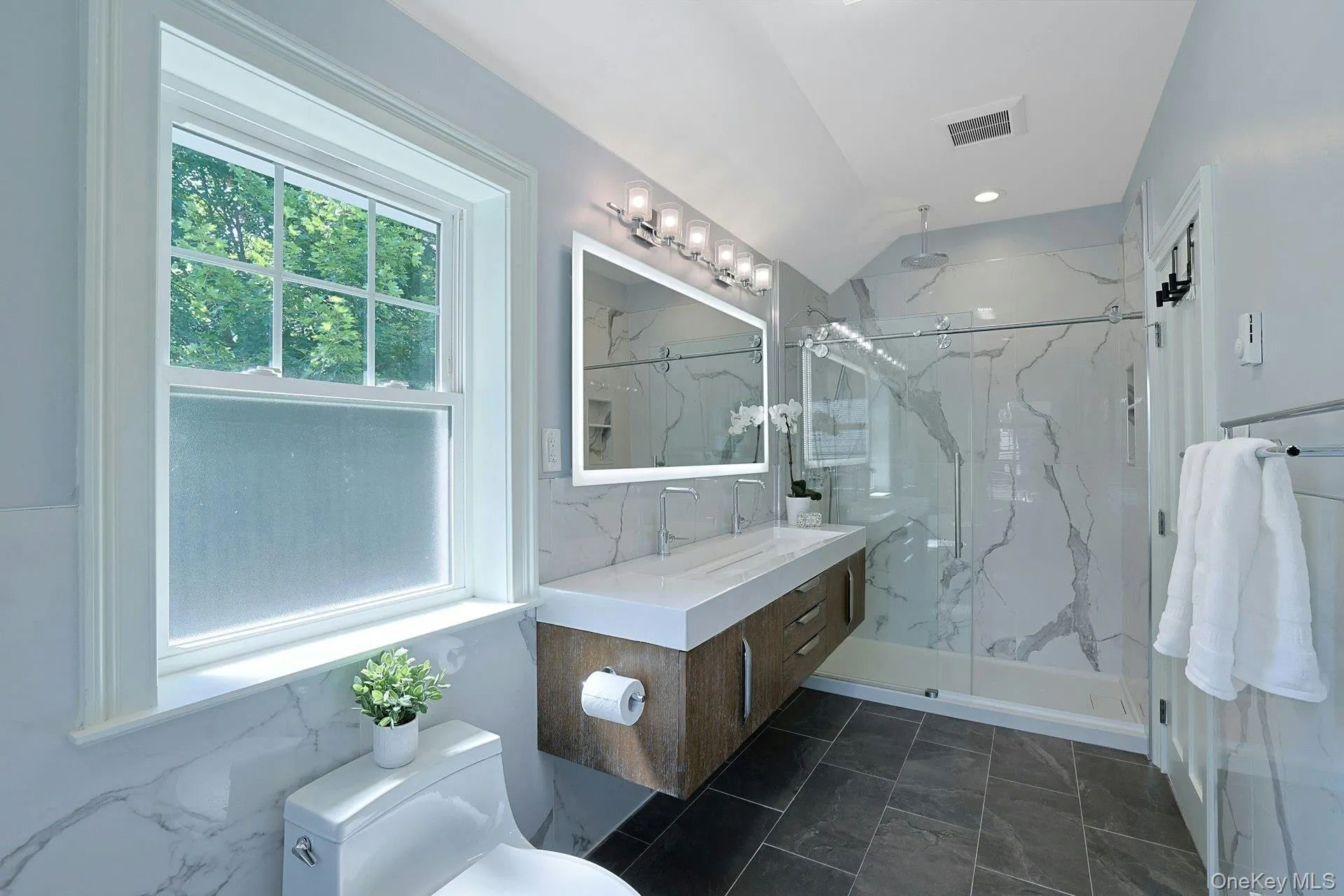 Designed for relaxation, the luxurious ensuite features premium finishes and a spacious glass-enclosed shower. Designed for relaxation, the luxurious ensuite features premium finishes and a spacious glass-enclosed shower.