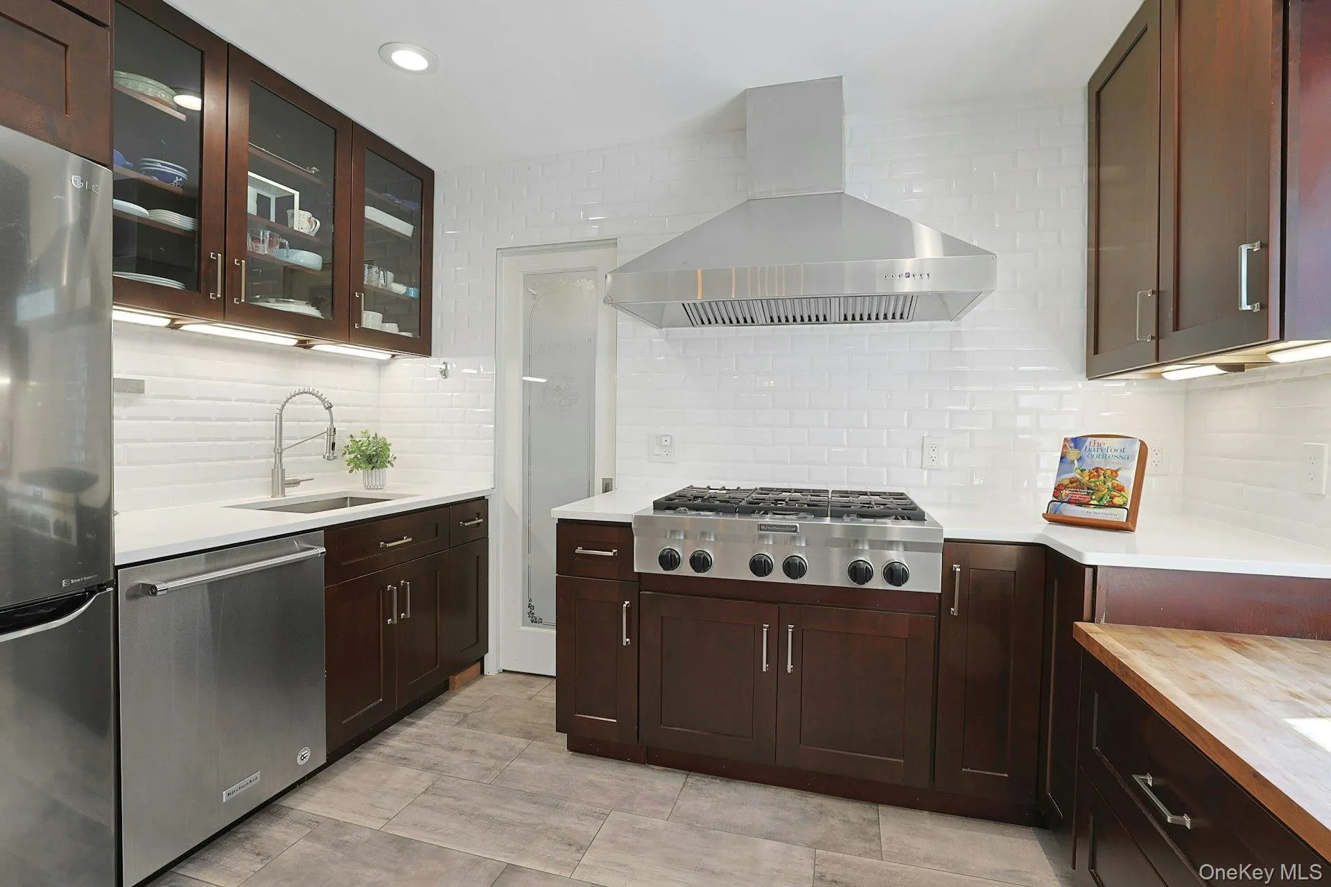 A well-appointed secondary kitchen with premium appliances including an additional fridge/freezer, sink and dishwasher and ample prep space. A well-appointed secondary kitchen with premium appliances including an additional fridge/freezer, sink and dishwasher and ample prep space.