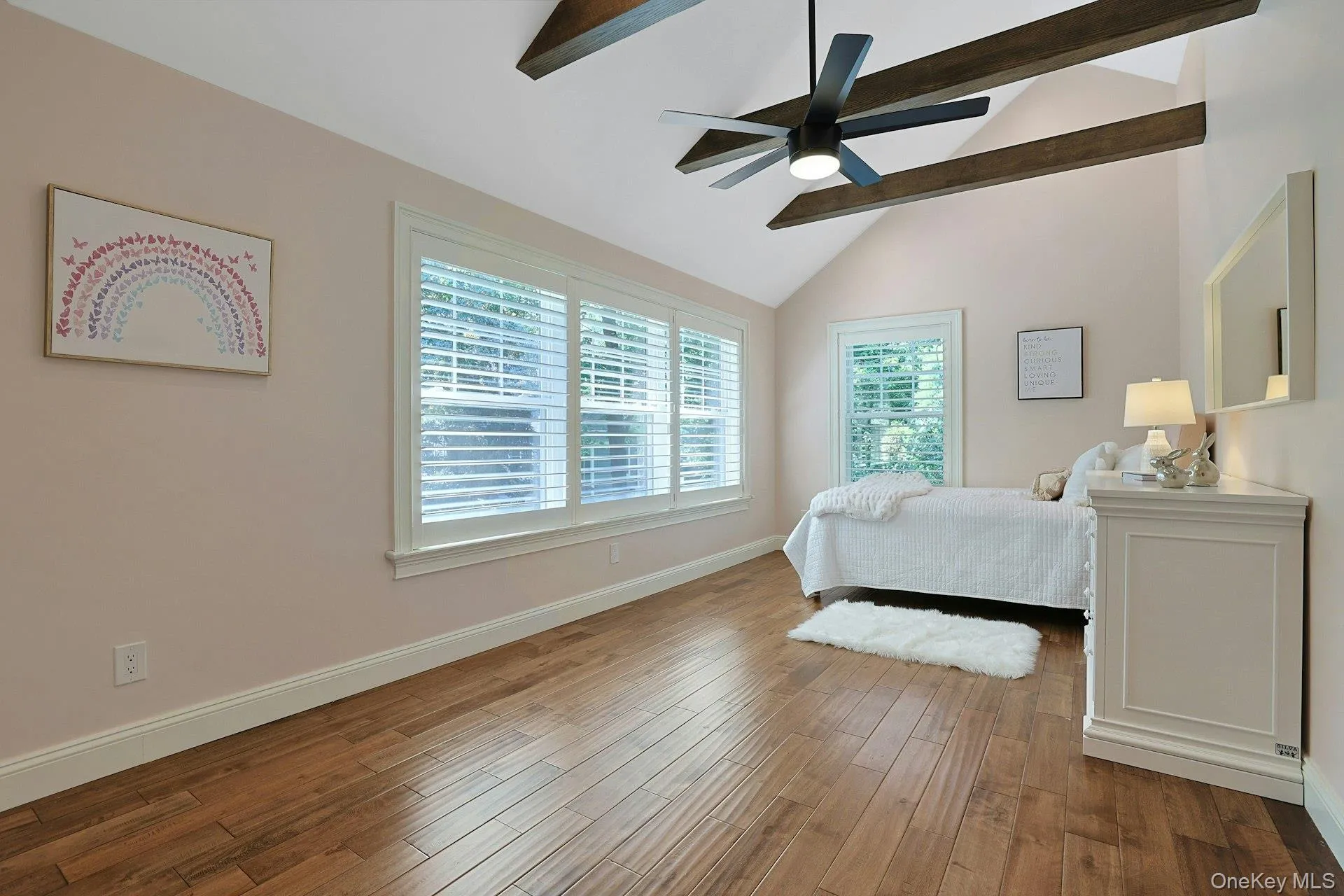 Spacious secondary bedroom with vaulted ceiling, ceiling fan, and a generous walk-in closet. Spacious secondary bedroom with vaulted ceiling, ceiling fan, and a generous walk-in closet.
