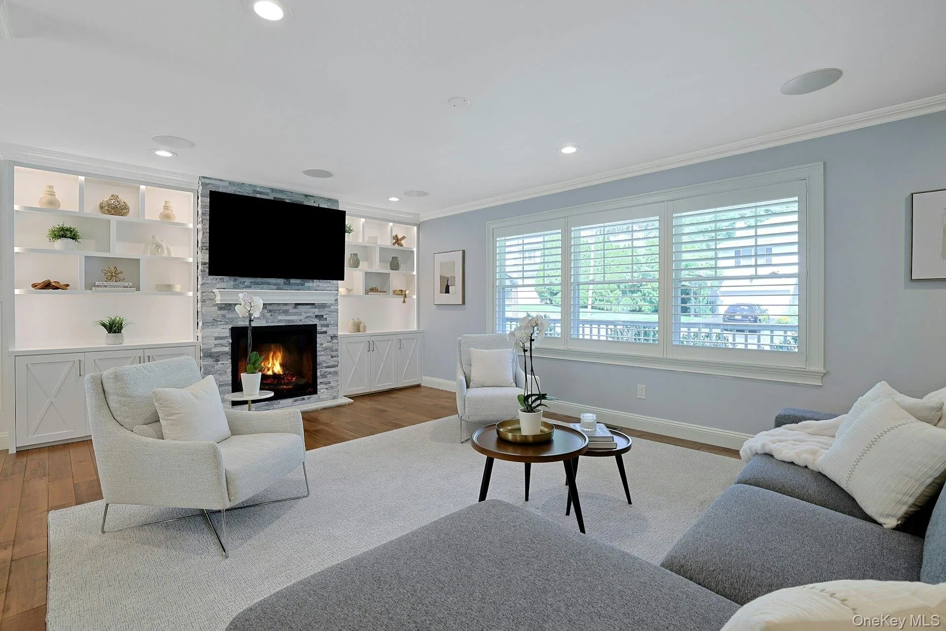 Sun-filled family room with custom built-ins, gas fireplace, and integrated speakers. Sun-filled family room with custom built-ins, gas fireplace, and integrated speakers.