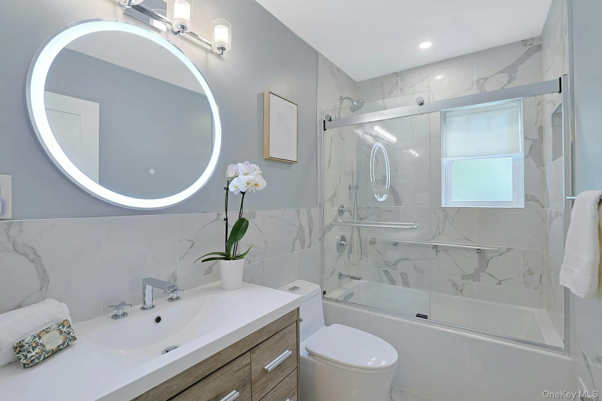 Beautifully renovated hall bath featuring a sleek vanity, designer tilework, and a tub/shower combination. Beautifully renovated hall bath featuring a sleek vanity, designer tilework, and a tub/shower combination.