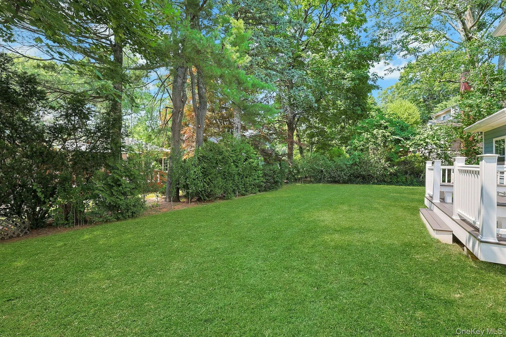 Expansive, level backyard framed by mature trees for privacy and recreation. Expansive, level backyard framed by mature trees for privacy and recreation.