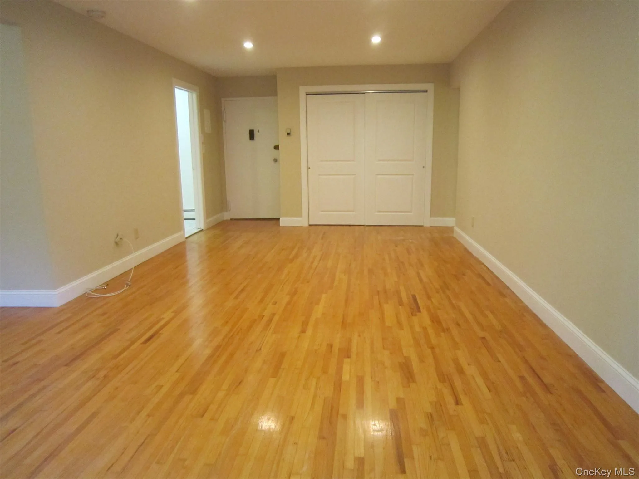 There's a huge living room with beautiful oak floors, recessed lighting and an oversized double coat closet. There's a huge living room with beautiful oak floors, recessed lighting and an oversized double coat closet.