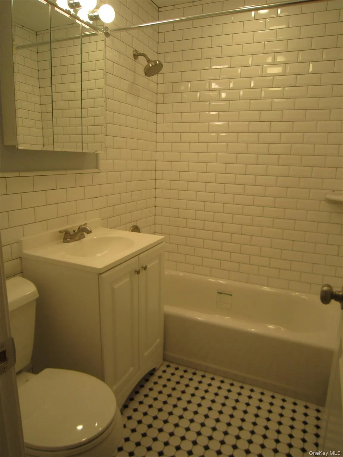 Beautifully updated ceramic tile bathroom with a shower/tub combination Beautifully updated ceramic tile bathroom with a shower/tub combination