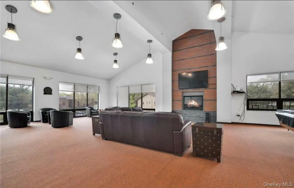 Large community lounge in clubhouse with firepalce, large screen tv, couches and games. Large community lounge in clubhouse with firepalce, large screen tv, couches and games.