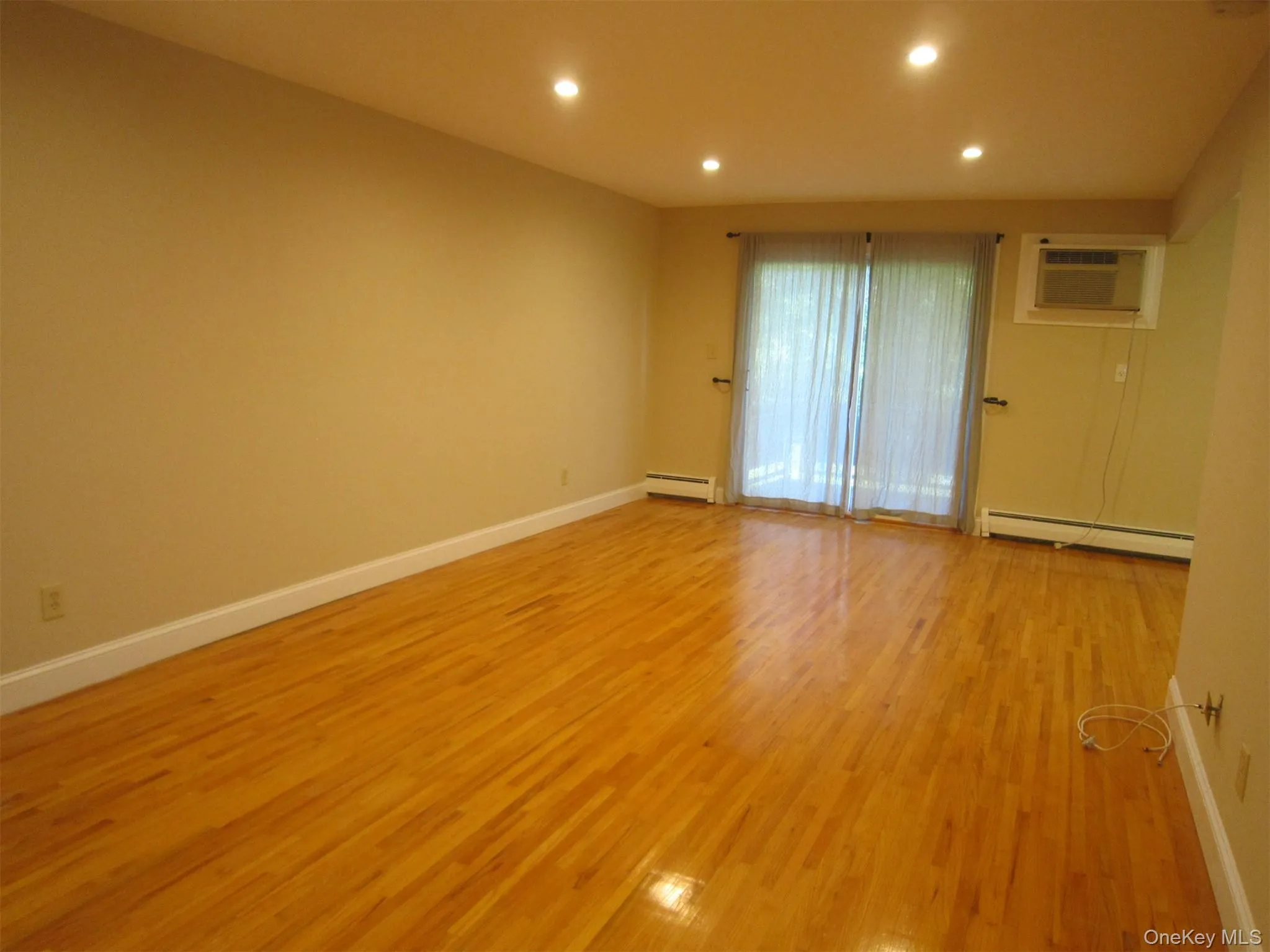 There are sliding glass doors leading to a private deck . There are sliding glass doors leading to a private deck .