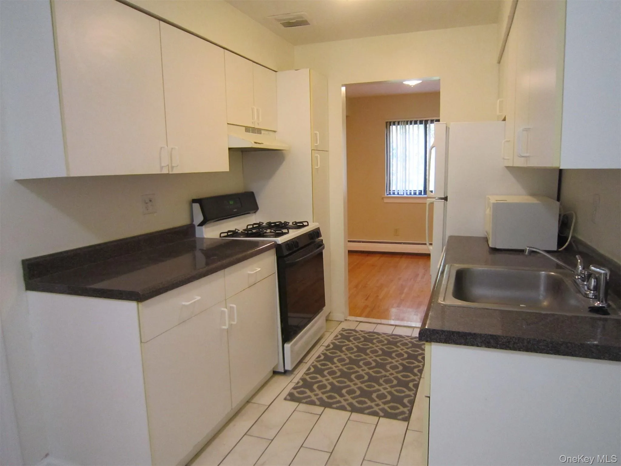 There's an updated kitchen with white cabinets, gas range, refrigerator and dishwasher, plus an informal dinette area which open to a spacious formal dining area There's an updated kitchen with white cabinets, gas range, refrigerator and dishwasher, plus an informal dinette area which open to a spacious formal dining area