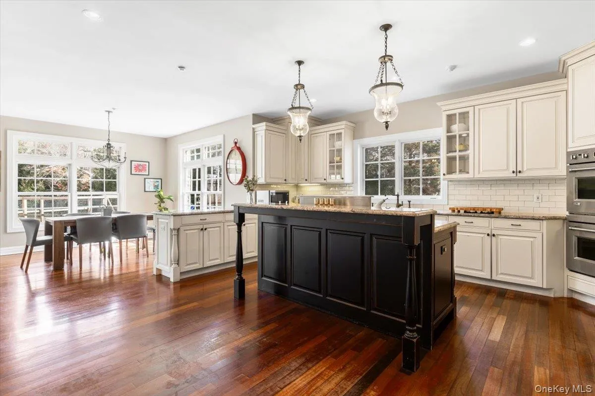 Chef's dream kitchen showing off premium granite counters, a wine fridge, and recessed lighting. Chef's dream kitchen showing off premium granite counters, a wine fridge, and recessed lighting.