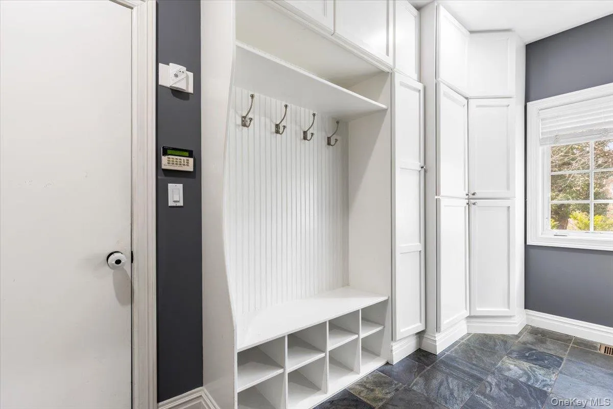 Highly functional custom mudroom directly off the garage with built-in cubbies and storage. Highly functional custom mudroom directly off the garage with built-in cubbies and storage.