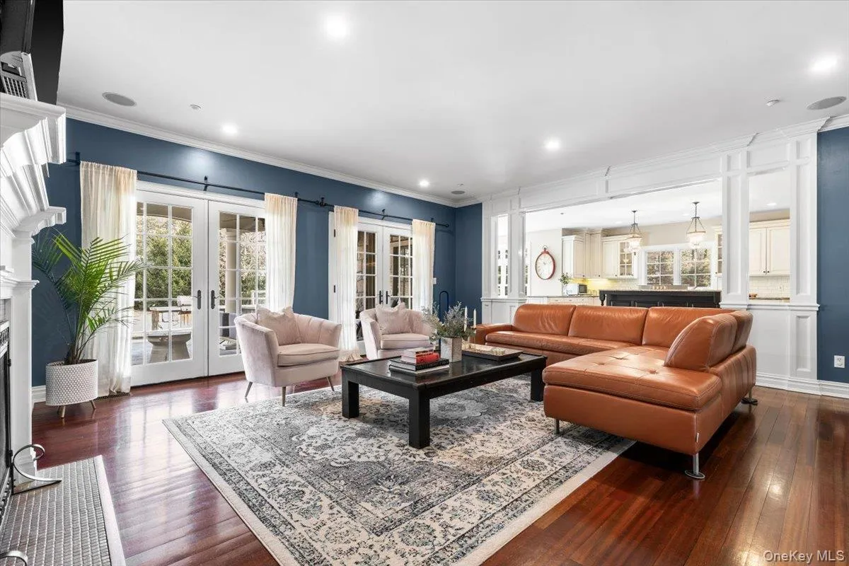 Cozy family room featuring a classic fireplace and elegant French doors stepping out to the rear patio. Cozy family room featuring a classic fireplace and elegant French doors stepping out to the rear patio.