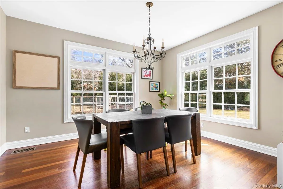 Casual dining space adjacent to the kitchen, framed by massive windows bringing in abundant natural light. Casual dining space adjacent to the kitchen, framed by massive windows bringing in abundant natural light.