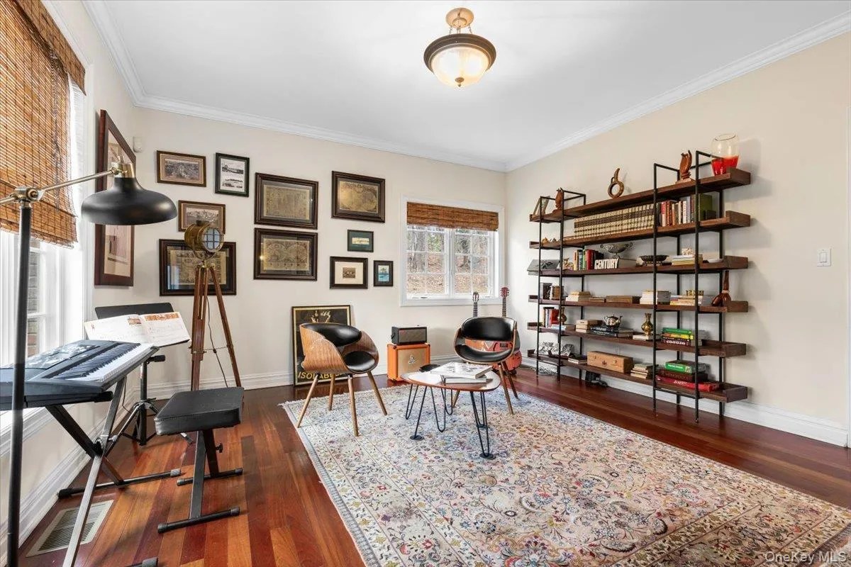 Bright and airy formal living room boasting handsome baseboards and rich hardwood floors. Bright and airy formal living room boasting handsome baseboards and rich hardwood floors.