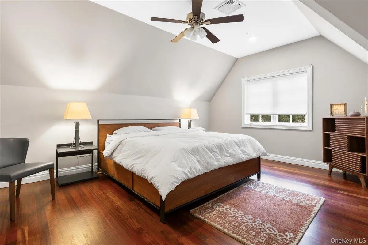 Light-filled third bedroom showcasing a stunning architectural vaulted ceiling. Light-filled third bedroom showcasing a stunning architectural vaulted ceiling.