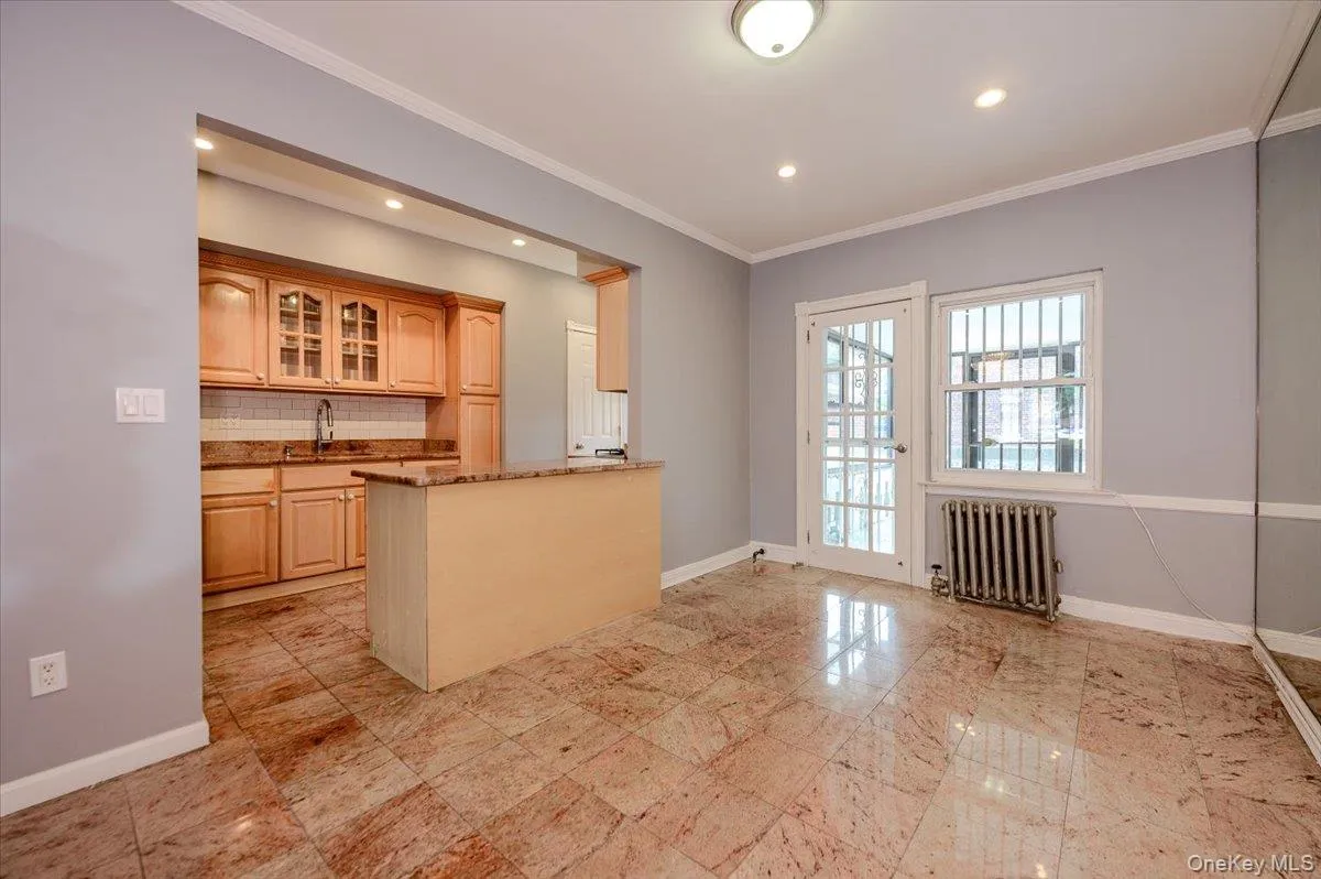Kitchen with wood cabinetry, backsplash, and recessed lighting Kitchen with wood cabinetry, backsplash, and recessed lighting
