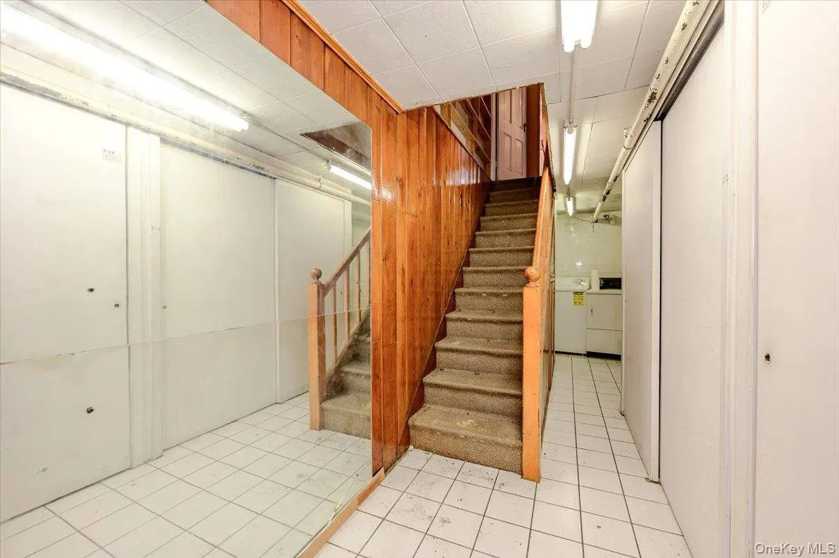 Wood paneling, tile flooring, interior staircase, built-in storage, fluorescent lighting Wood paneling, tile flooring, interior staircase, built-in storage, fluorescent lighting