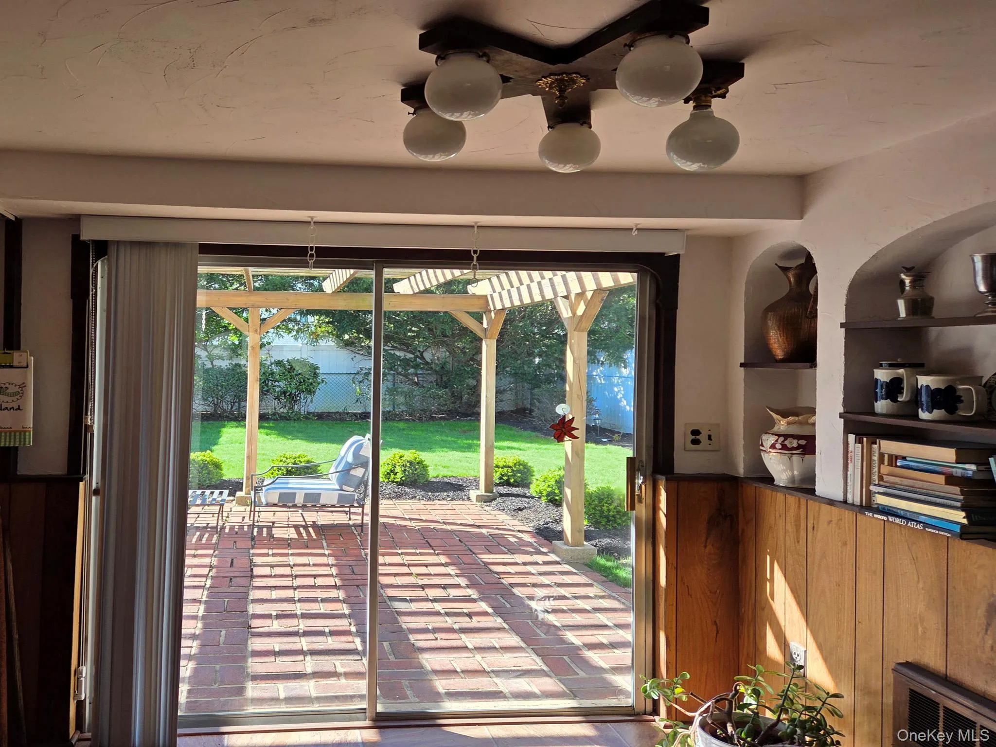 Glass sliders to the brick patio and pergola Glass sliders to the brick patio and pergola
