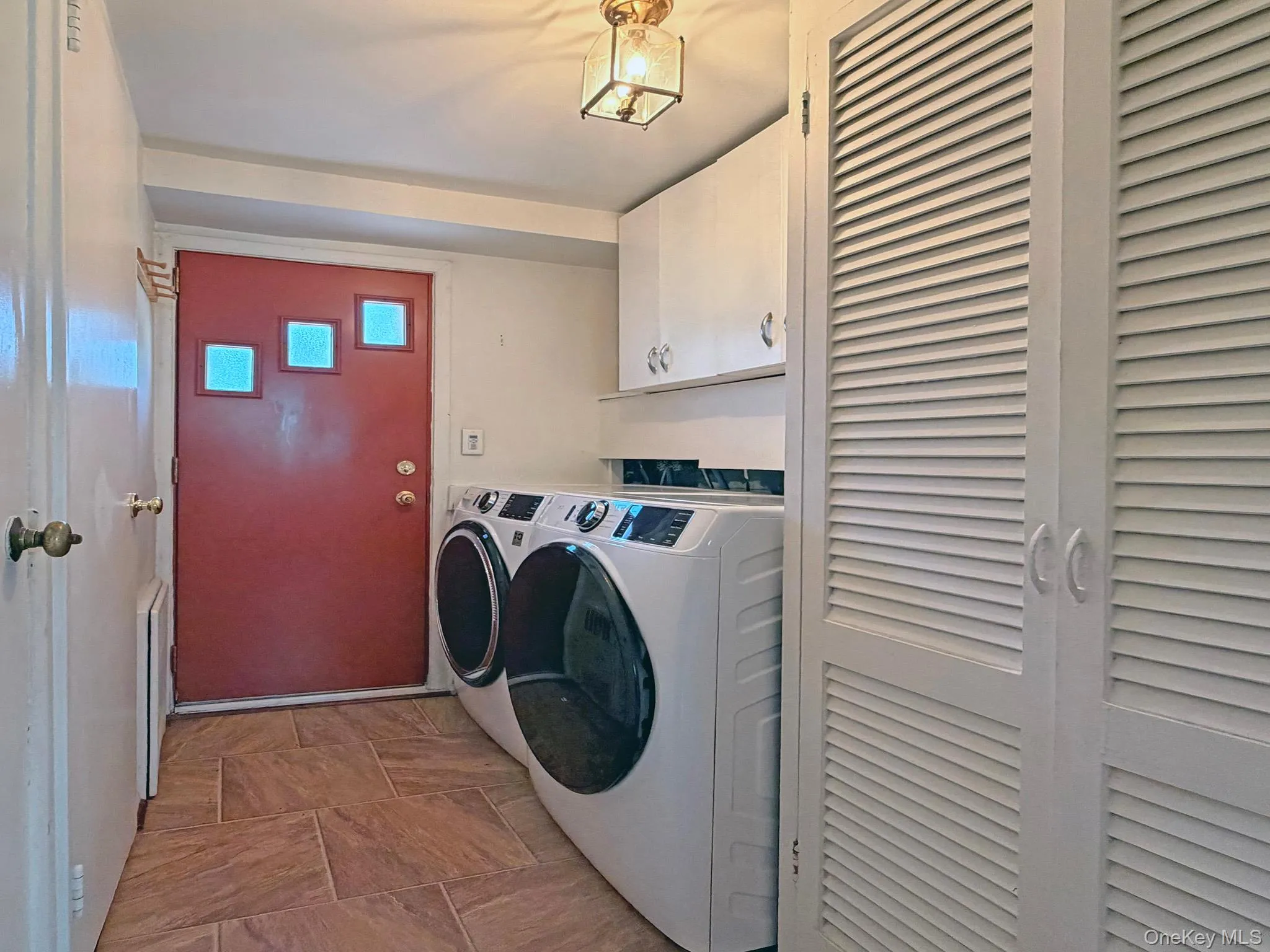 Dedicated laundry area featuring modern front-loading appliances Dedicated laundry area featuring modern front-loading appliances