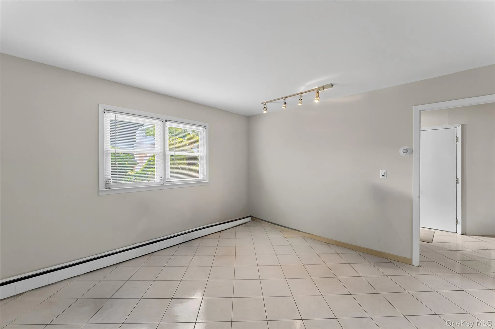 Light-toned tile flooring throughout Light-toned tile flooring throughout