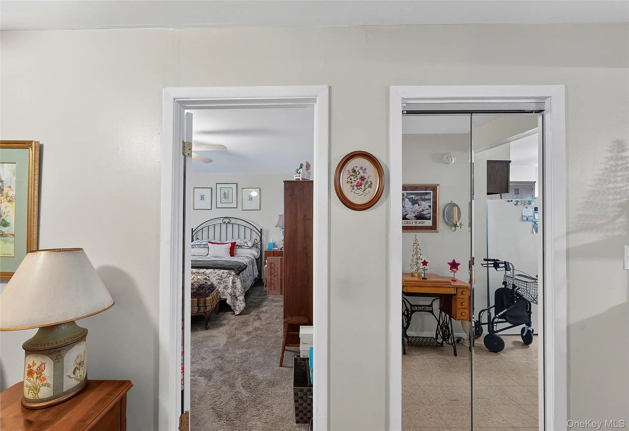 Interior doorway leading to a carpeted room with a ceiling fan Interior doorway leading to a carpeted room with a ceiling fan