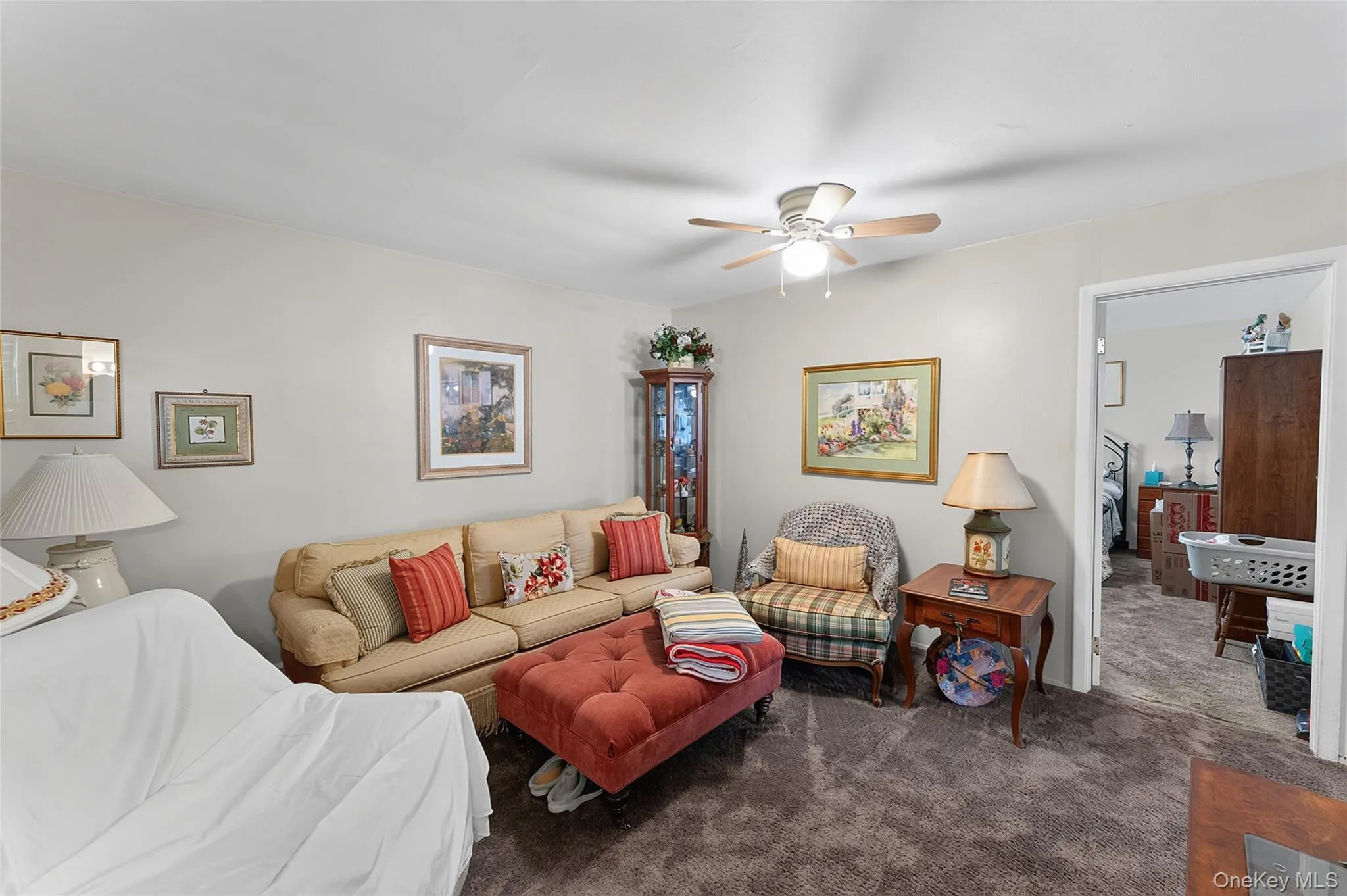 Living area featuring neutral wall paint, ceiling fan with integrated lighting, and carpet flooring Living area featuring neutral wall paint, ceiling fan with integrated lighting, and carpet flooring