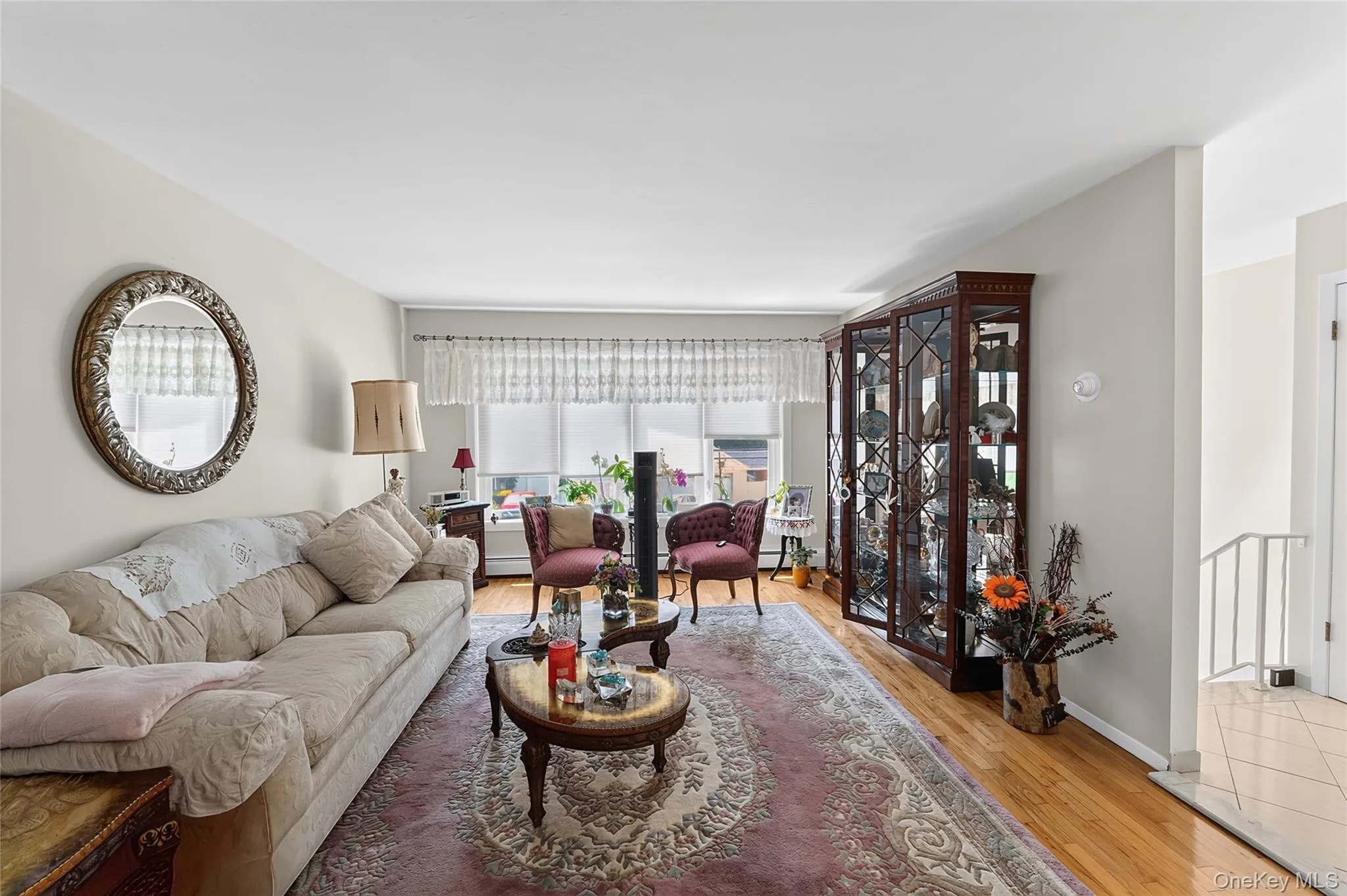 Living space featuring hardwood flooring and light-toned walls Living space featuring hardwood flooring and light-toned walls