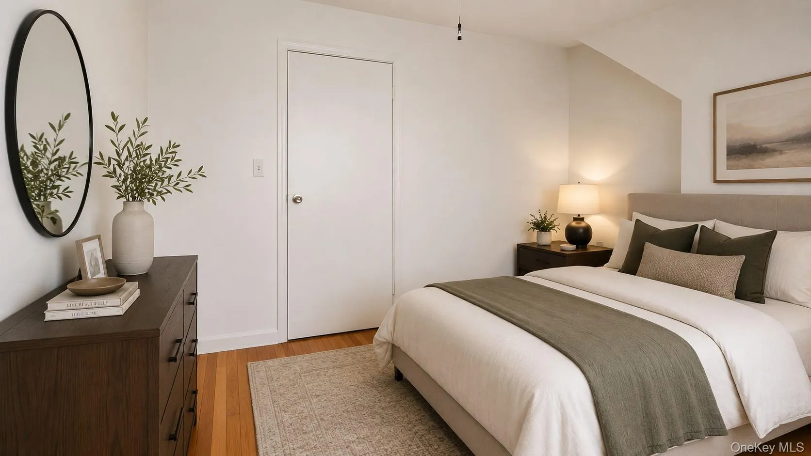 Bedroom featuring hardwood flooring, a large window, and a built-in radiator Bedroom featuring hardwood flooring, a large window, and a built-in radiator