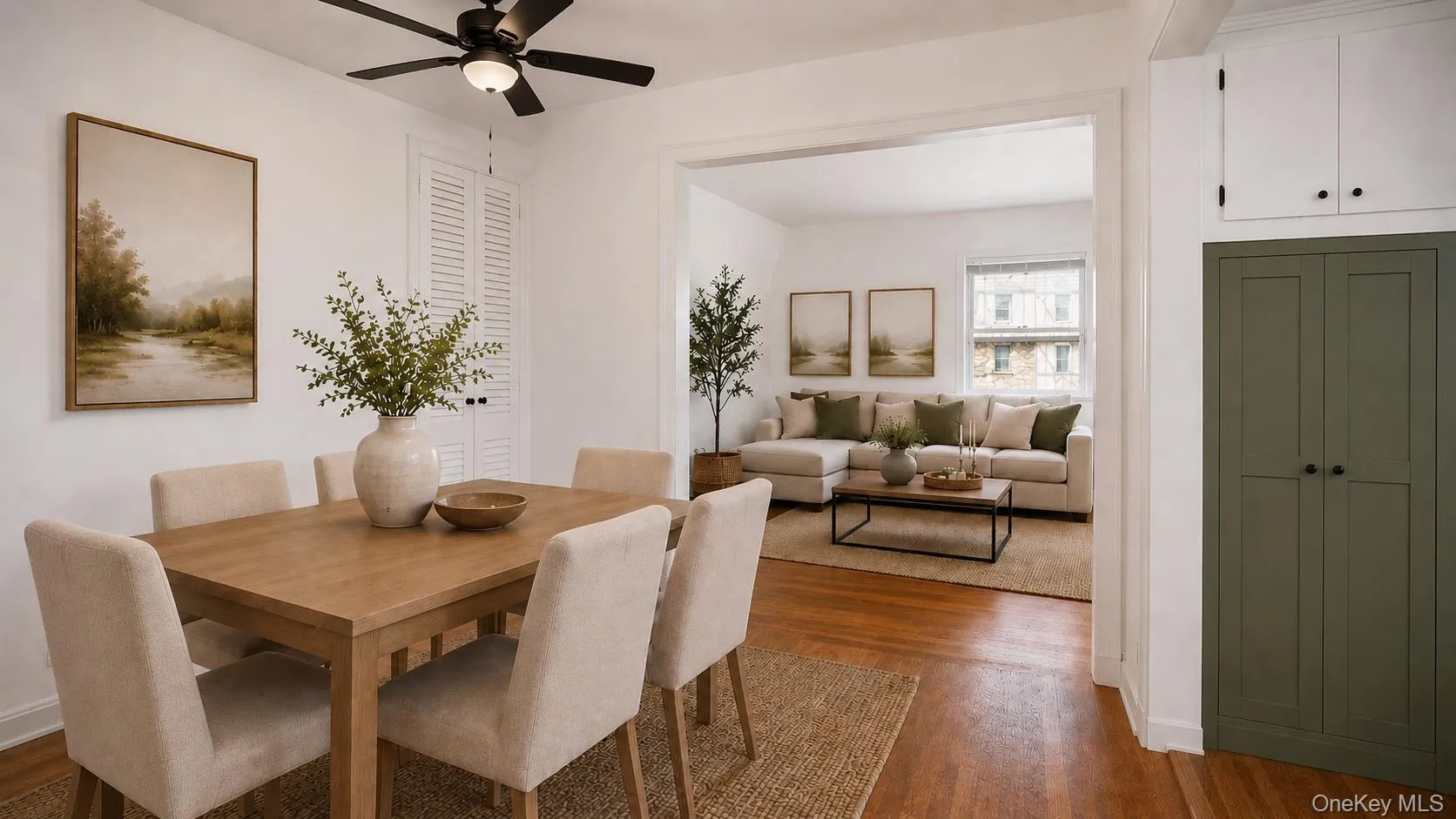 Dining area featuring wood-finish flooring and a ceiling fan Dining area featuring wood-finish flooring and a ceiling fan