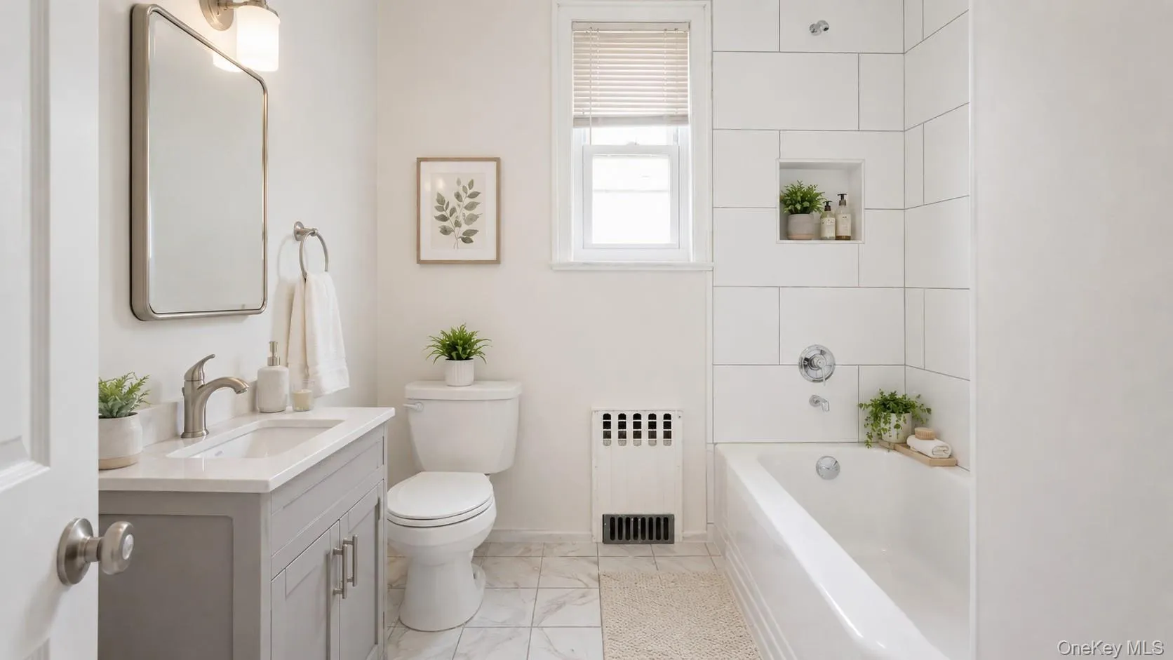 Bathroom featuring a rectangular vanity with a white countertop and undermount sink Bathroom featuring a rectangular vanity with a white countertop and undermount sink