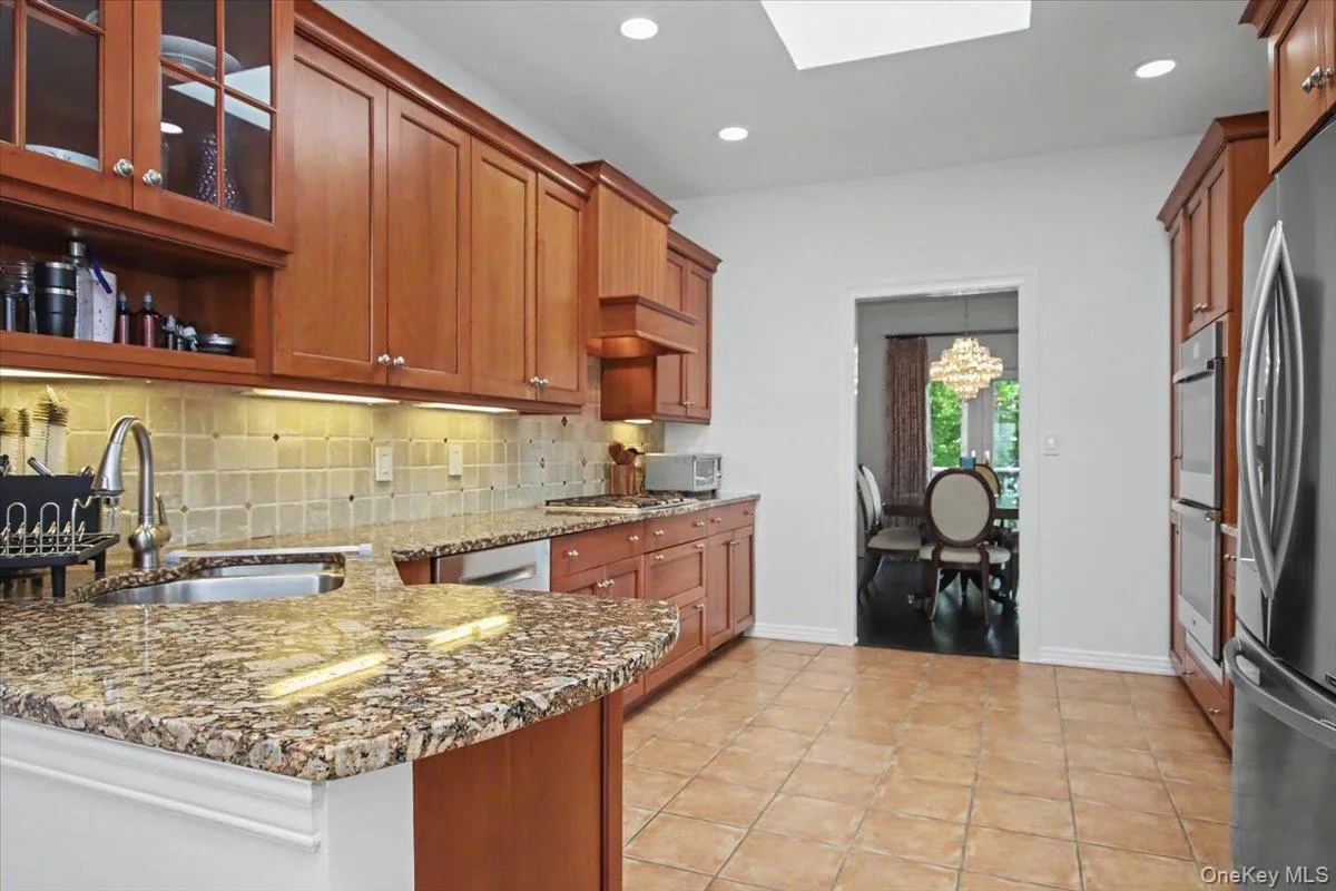 Granite counters, wood cabinets, ceramic tiled floor. Granite counters, wood cabinets, ceramic tiled floor.