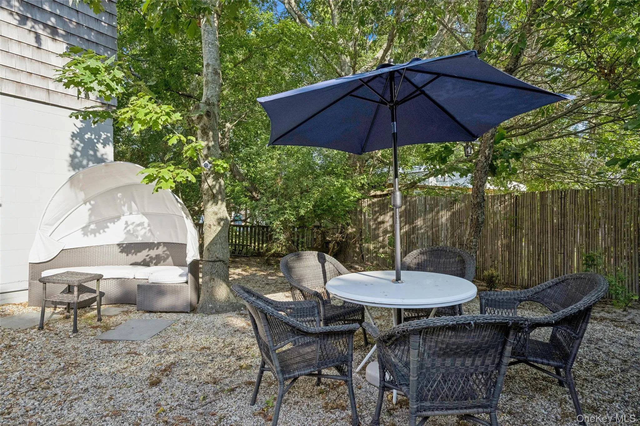 Outdoor patio area featuring gravel surfacing and mature trees Outdoor patio area featuring gravel surfacing and mature trees