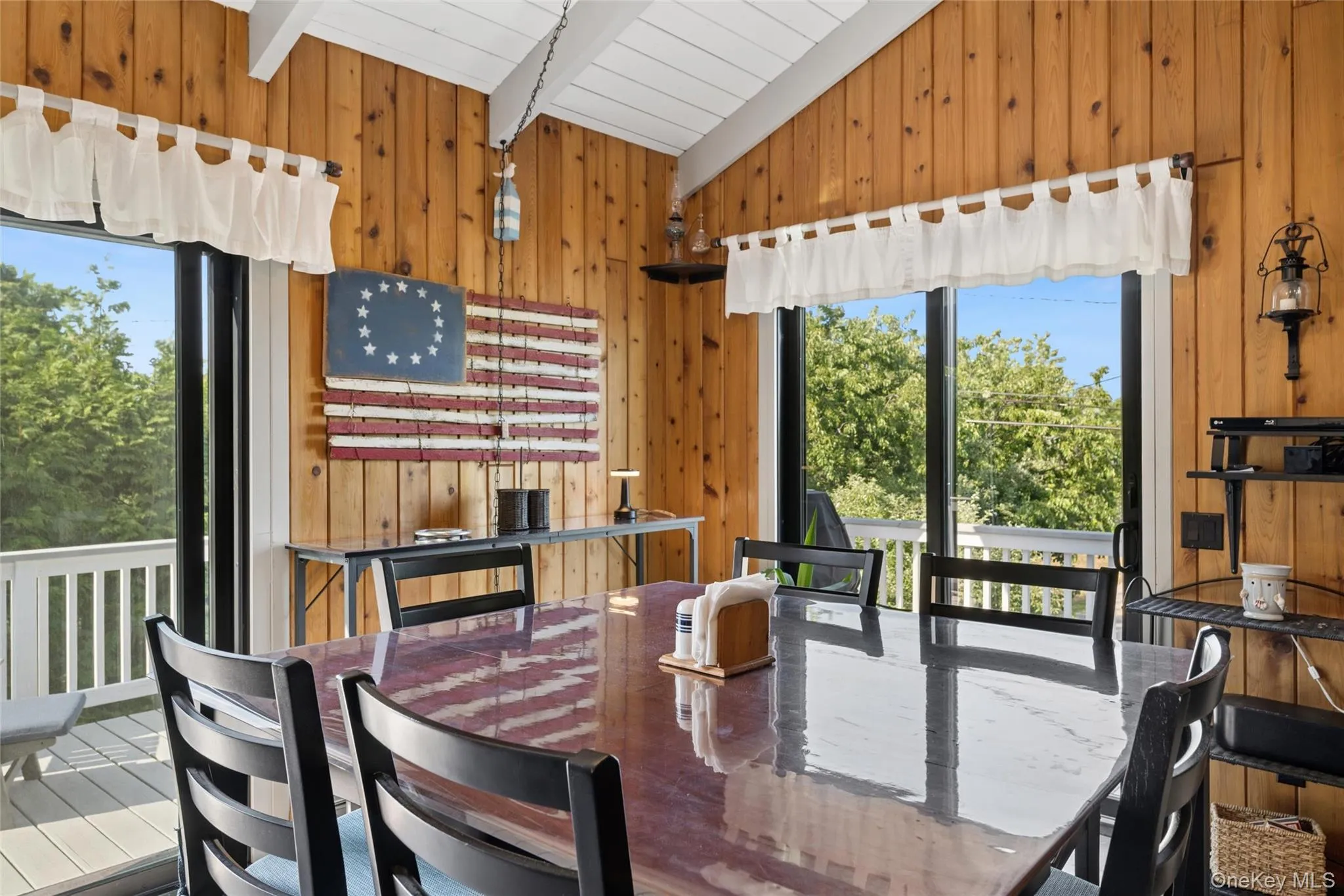 Dining area featuring extensive wood paneling and a vaulted ceiling Dining area featuring extensive wood paneling and a vaulted ceiling