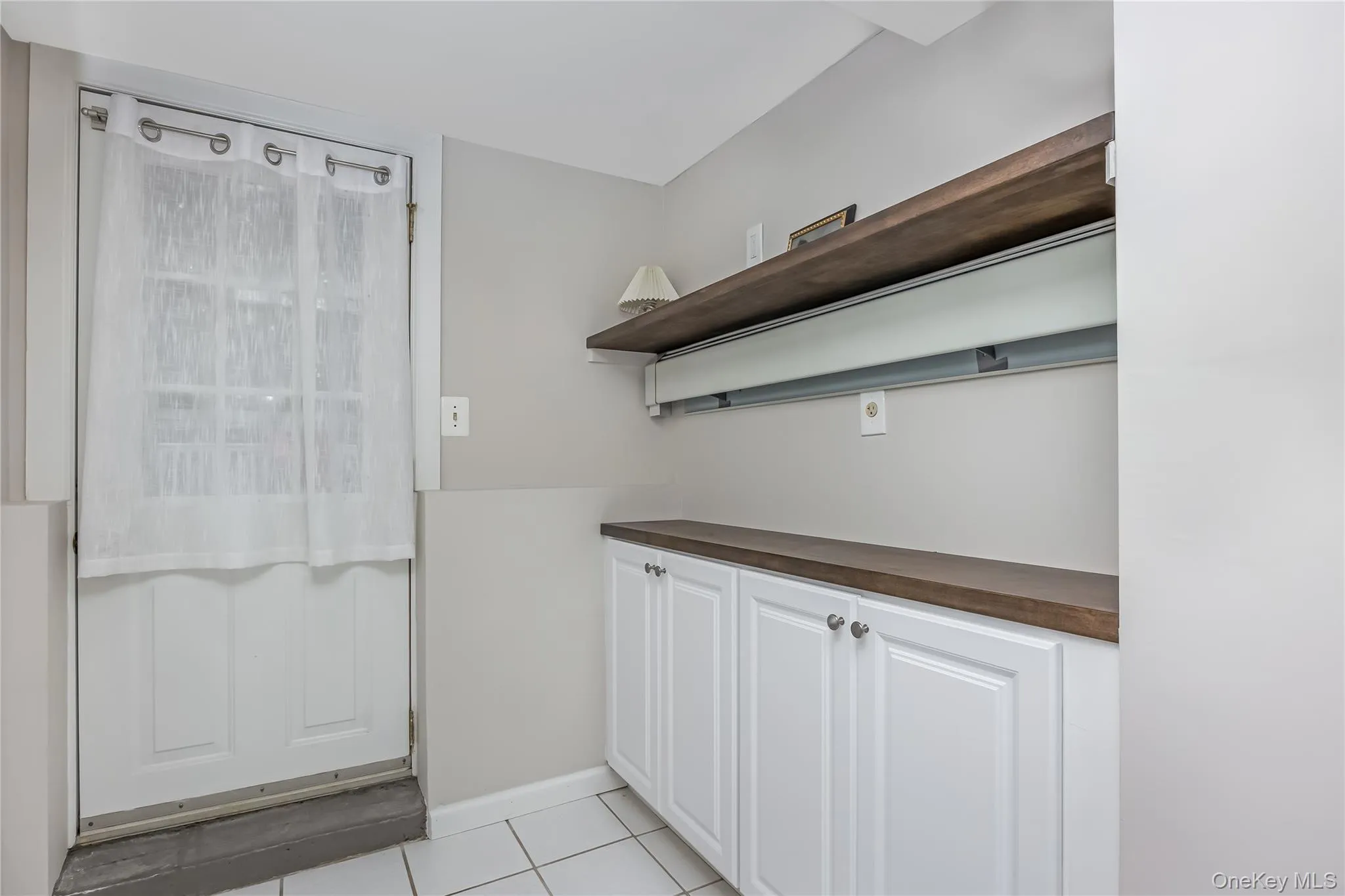 Mud room with access to/from the yard and storage cabinets Mud room with access to/from the yard and storage cabinets
