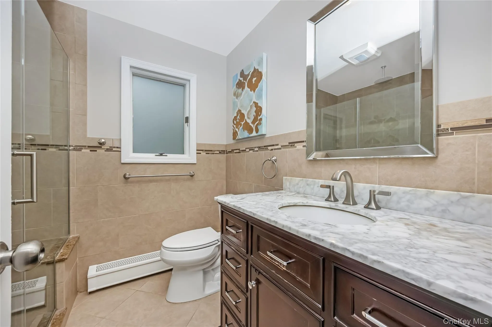 Bathroom featuring a dark wood vanity with a white quartz countertop, an undermount sink, and a brushed nickel faucet and a large glass enclosed shower Bathroom featuring a dark wood vanity with a white quartz countertop, an undermount sink, and a brushed nickel faucet and a large glass enclosed shower