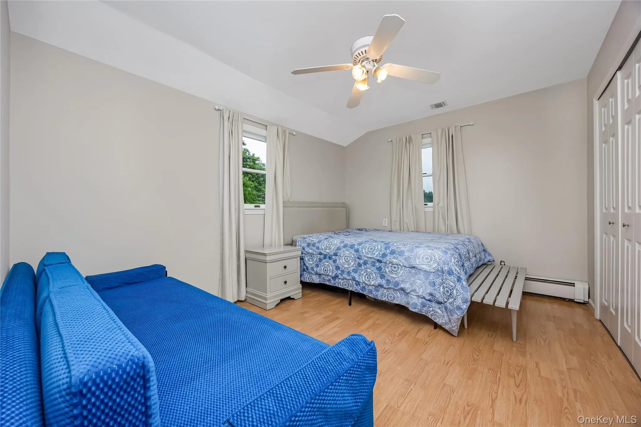 Bedroom with light vinyl flooring and neutral wall tones Bedroom with light vinyl flooring and neutral wall tones