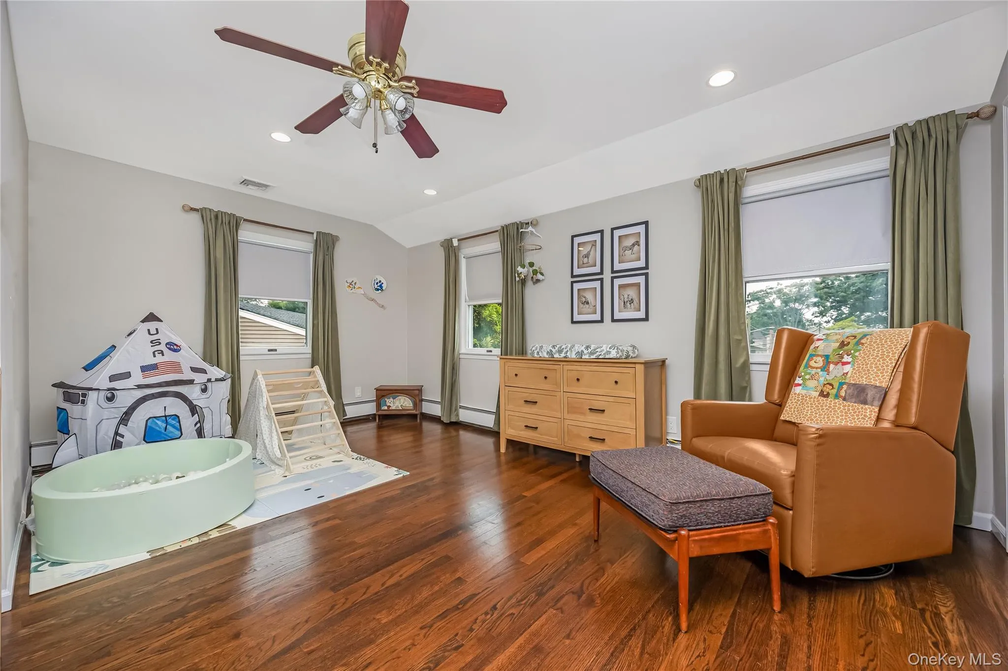 Large bedroom with sun drenching windows, a built in bookcase and closet Large bedroom with sun drenching windows, a built in bookcase and closet