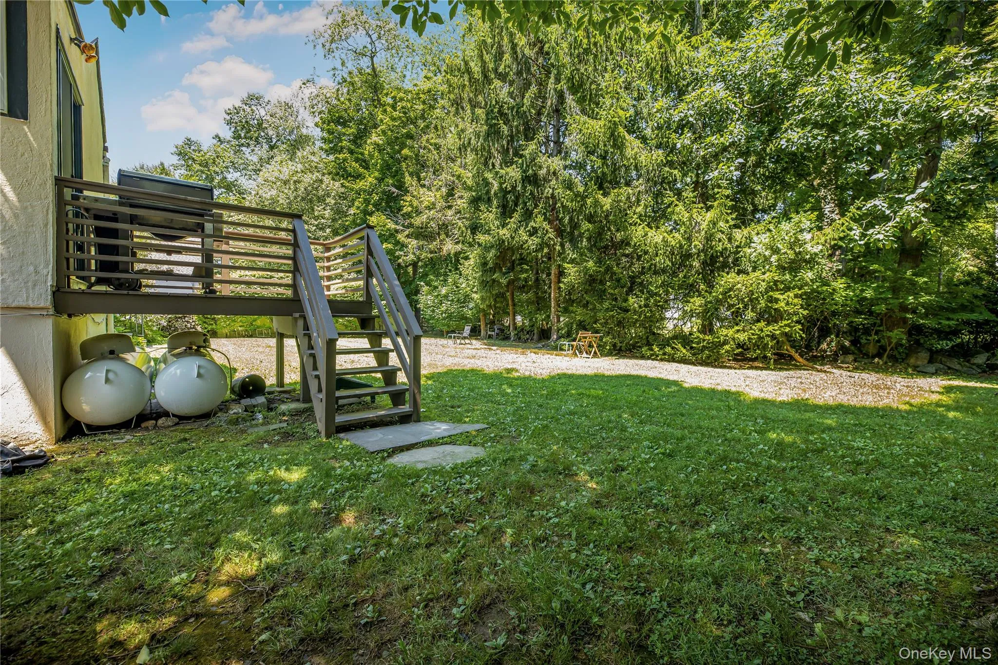 Elevated rear deck overlooking the expansive backyard, providing an ideal setting for outdoor dining, entertaining, or relaxing. Elevated rear deck overlooking the expansive backyard, providing an ideal setting for outdoor dining, entertaining, or relaxing.