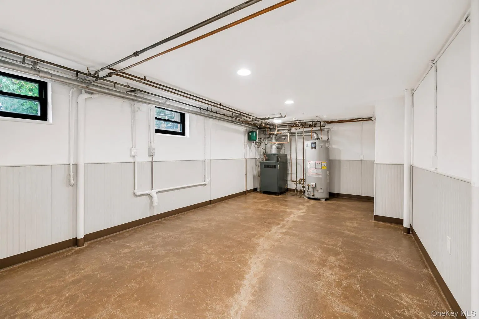 Spacious utility and laundry room with direct exterior access and abundant storage. Virtually enhanced. Spacious utility and laundry room with direct exterior access and abundant storage. Virtually enhanced.