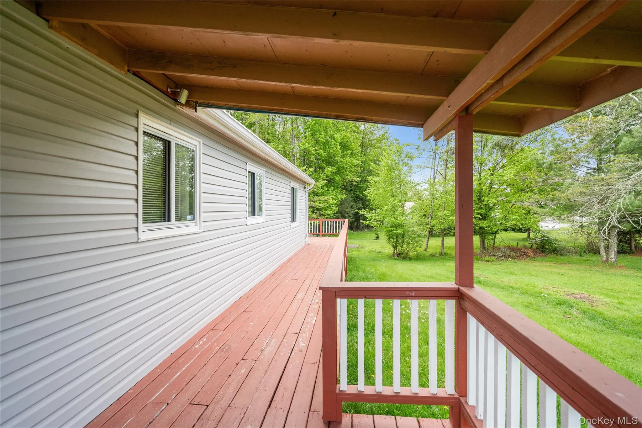 Wooden deck featuring a yard Wooden deck featuring a yard