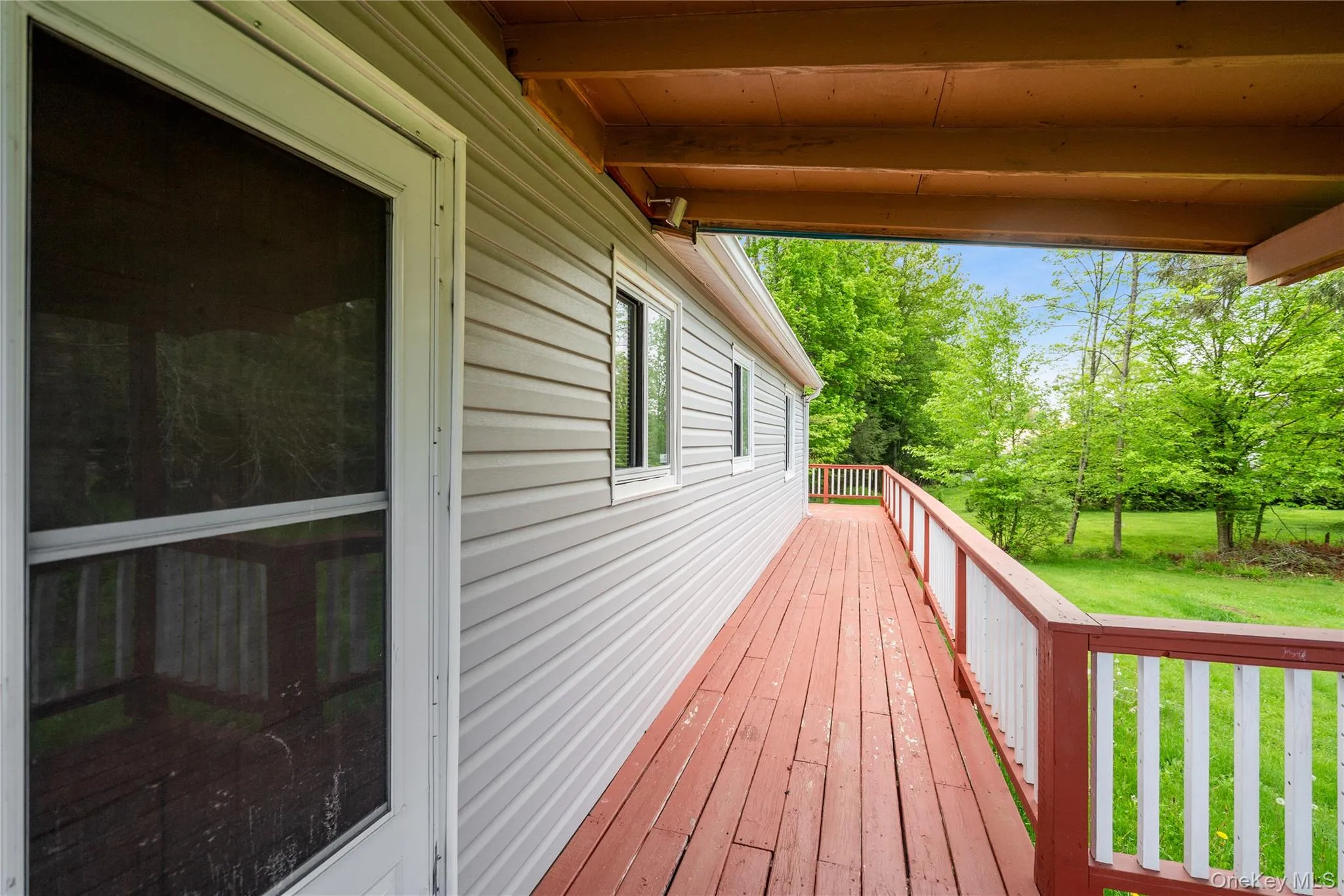 Wooden deck featuring a lawn Wooden deck featuring a lawn