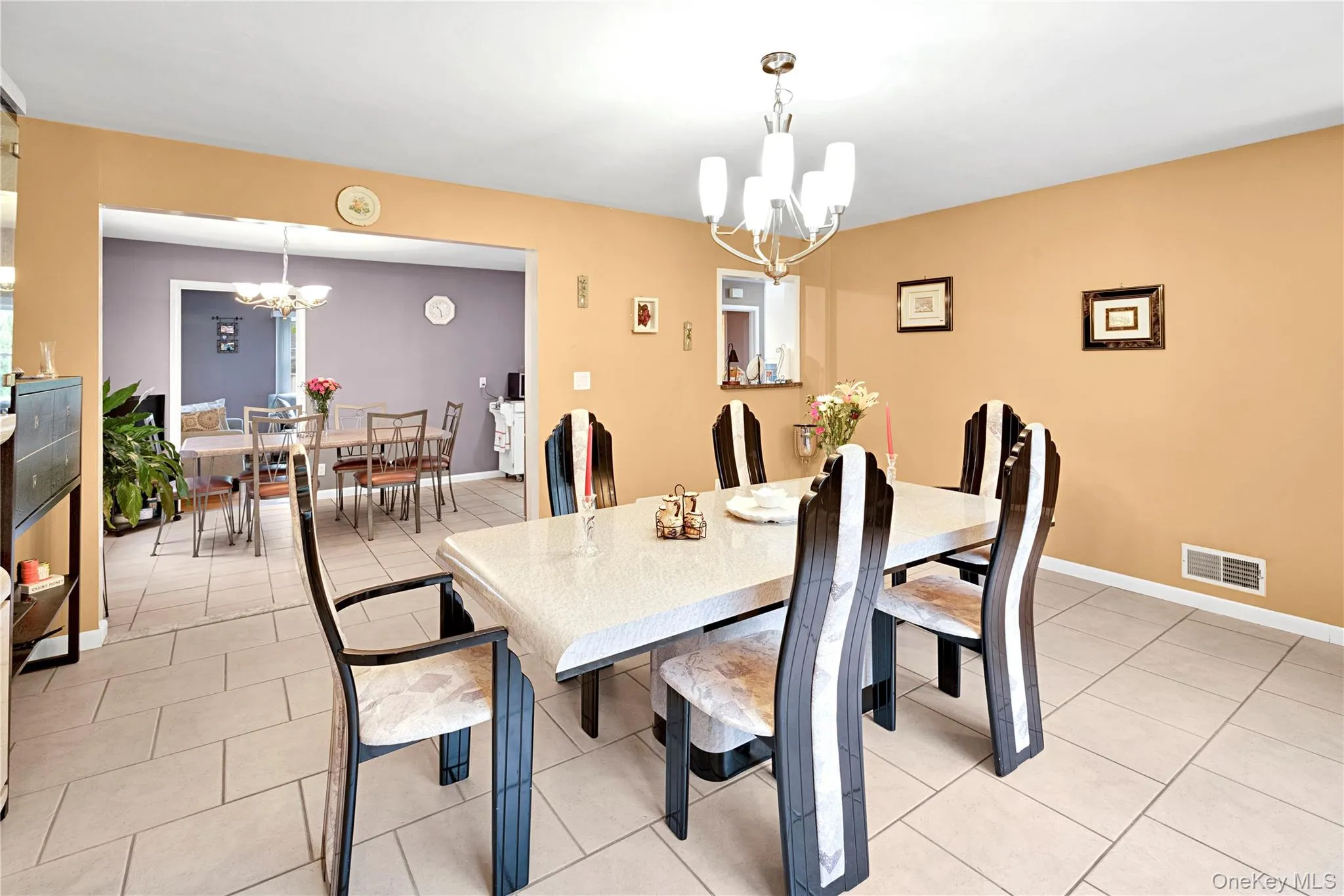 View of dining/family room with eat in kitchen dining area in the background. View of dining/family room with eat in kitchen dining area in the background.