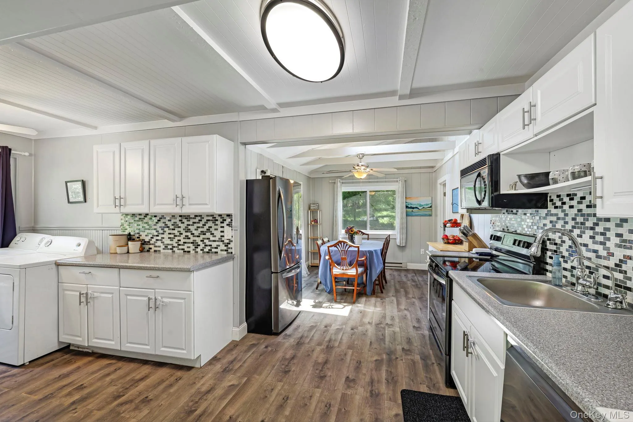 Kitchen with laundry space for convenience and new flooring Kitchen with laundry space for convenience and new flooring