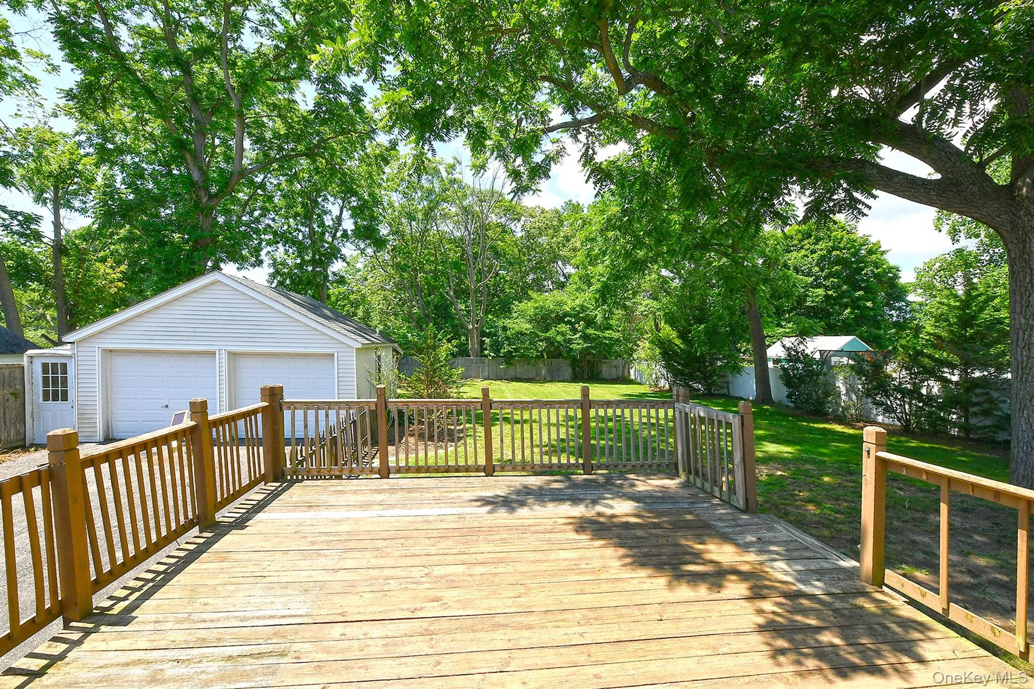 View from Eating area of Deck and garage into yard (over one third of an acre). View from Eating area of Deck and garage into yard (over one third of an acre).
