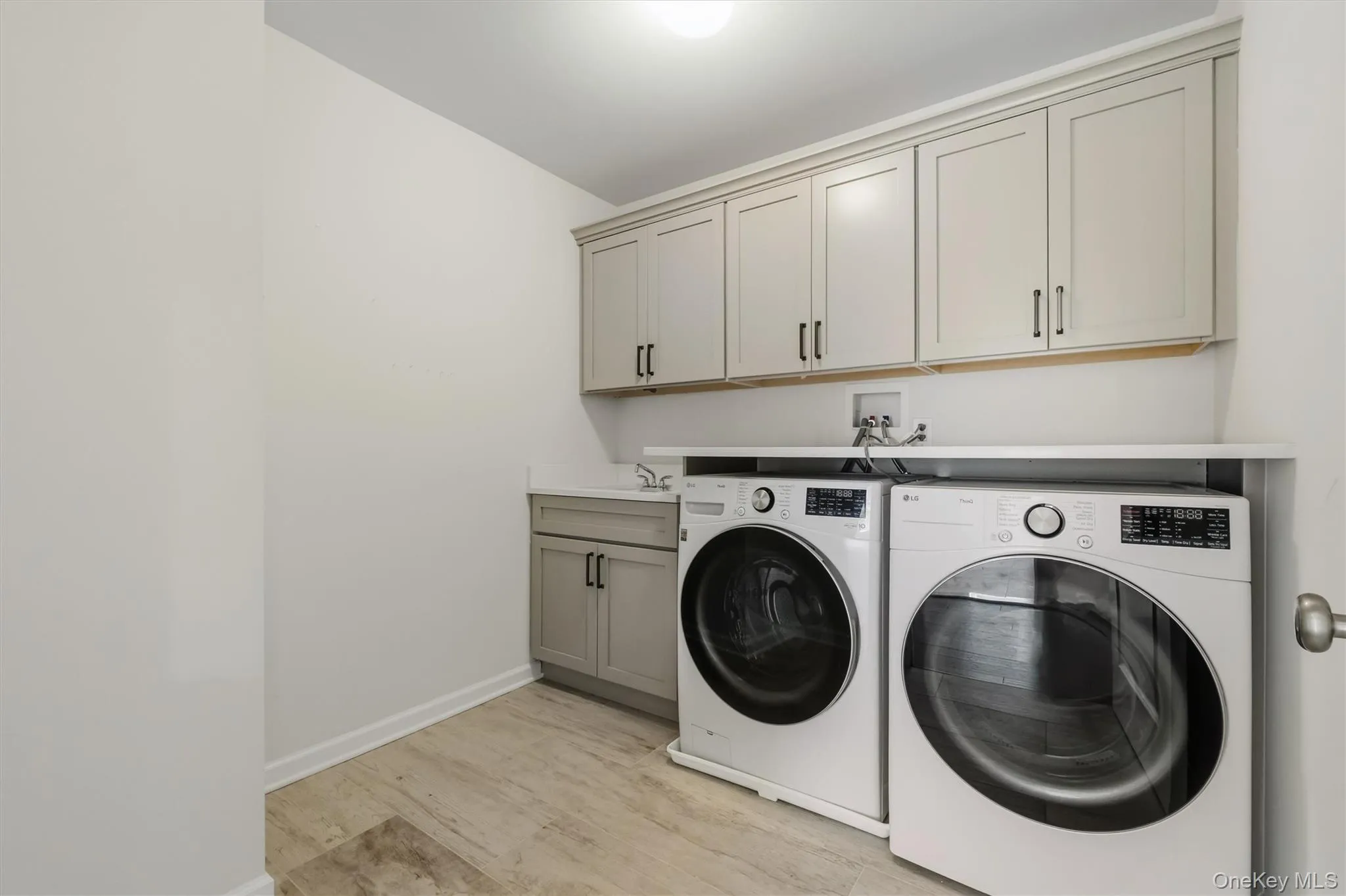 laundry room with washer. dryer, sink and tons of storage. laundry room with washer. dryer, sink and tons of storage.