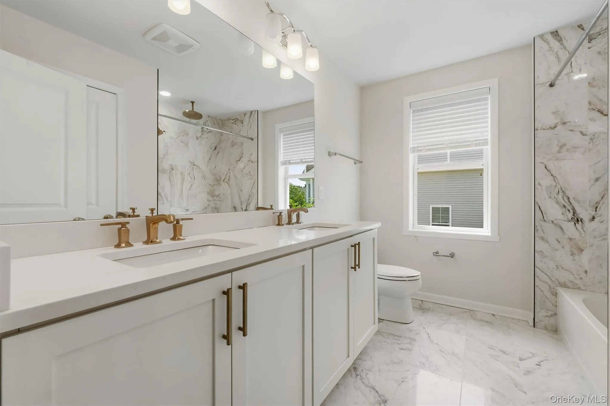 Hall bathroom with dual vanity, shower and closet. Hall bathroom with dual vanity, shower and closet.