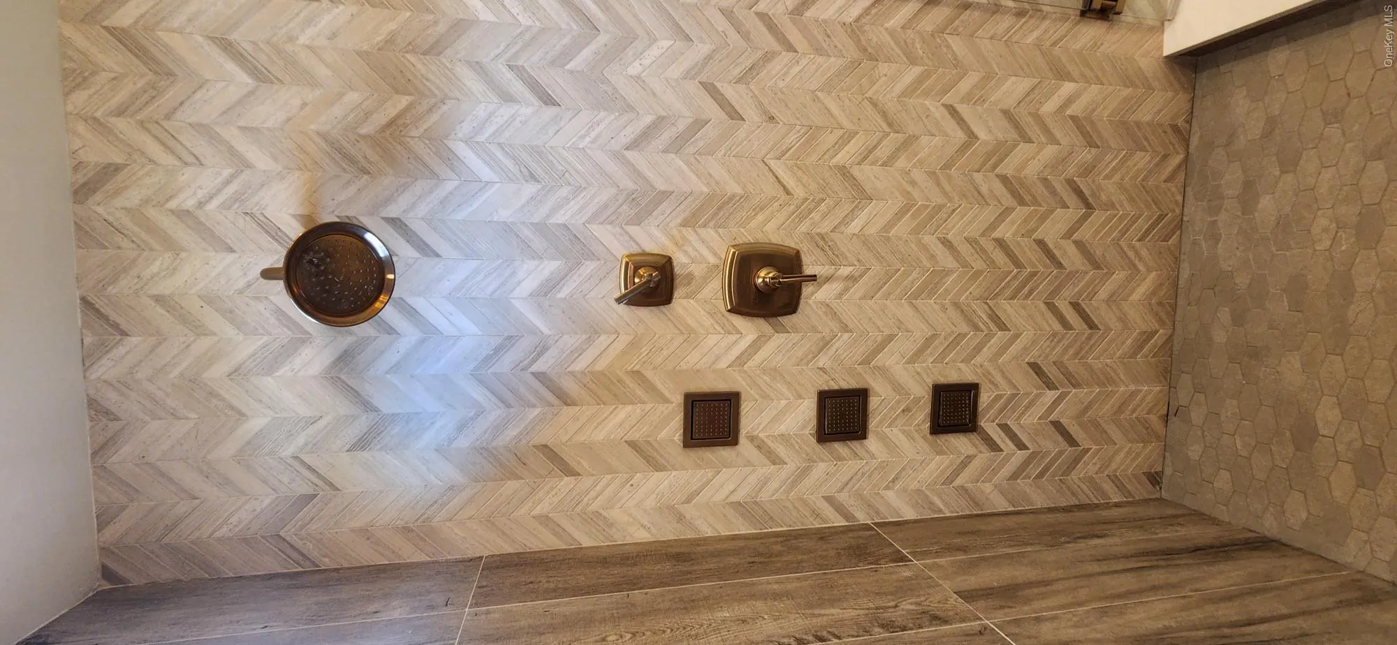 Multiple shower heads and jets in master bathroom shower. Multiple shower heads and jets in master bathroom shower.