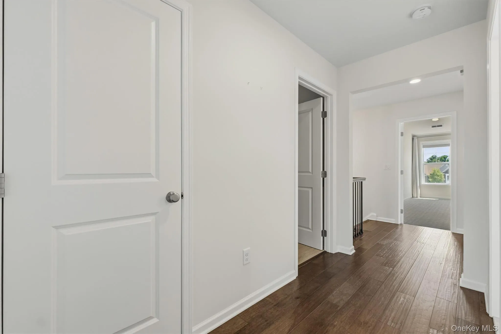 Hardwood-finish flooring extending through the hallway. Hardwood-finish flooring extending through the hallway.